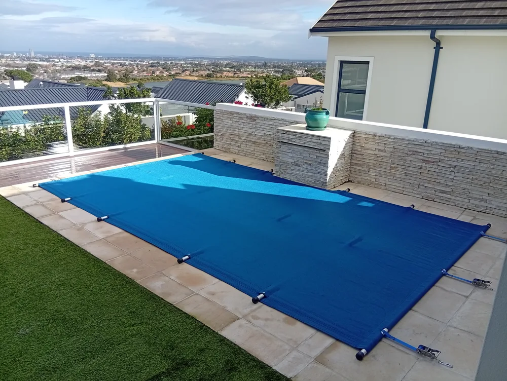 Pool cover fitted on a Strand home with a coastal view